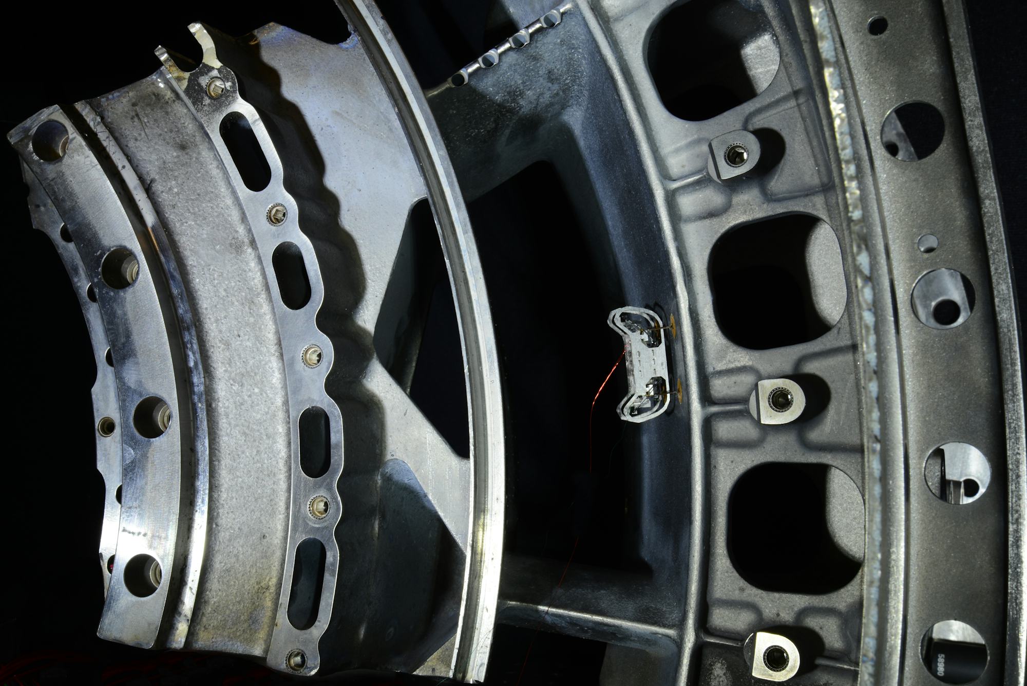 HAMR-E on a curved engine-section wall; its tether is visible.