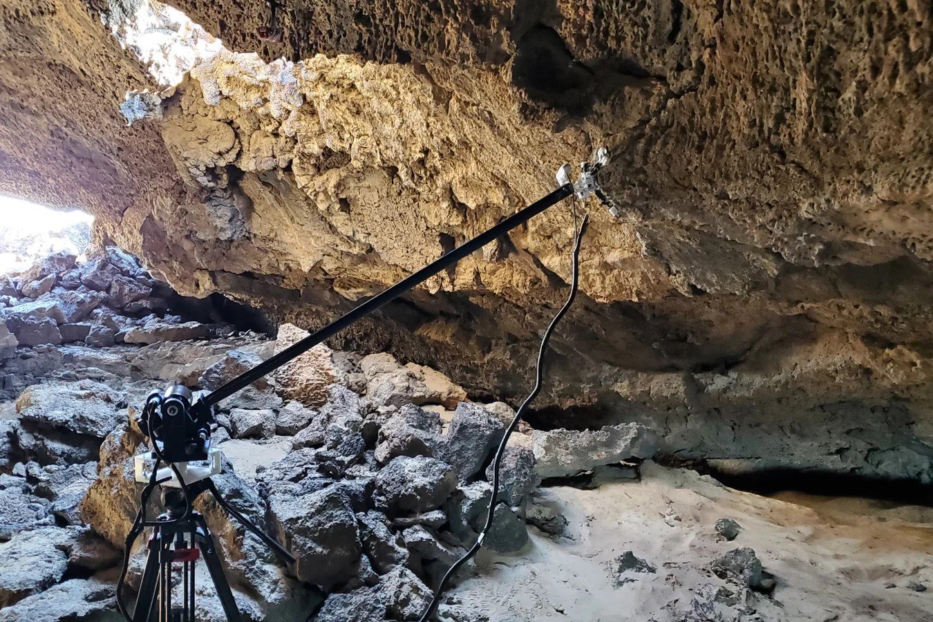 Teleoperated single-boom tests in a lava tube, with a tripod, boom and gripper.